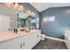 Elegant bathroom with double vanity, hexagon tile, and soaking tub at 15263 W 69Th Ave, Arvada, CO 80007