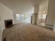 Spacious living room with fireplace and adjacent kitchen at 11479 E 1St Ave, Aurora, CO 80010