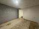 Unfinished basement with concrete floors and a door at 11479 E 1St Ave, Aurora, CO 80010