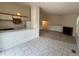 Kitchen with white cabinets and view into living room at 11479 E 1St Ave, Aurora, CO 80010