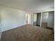 Spacious bedroom featuring mirrored closet doors and neutral carpeting at 11479 E 1St Ave, Aurora, CO 80010