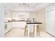 Modern kitchen with white cabinetry, granite island, and tile floors at 4605 S Yosemite St # 301, Denver, CO 80237