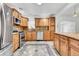 Updated kitchen featuring wood cabinets and granite countertops at 1219 Tucson St, Aurora, CO 80011