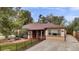 House exterior showcasing a charming ranch home with a landscaped yard at 1219 Tucson St, Aurora, CO 80011