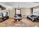 Spacious living room with tile floors, large windows, and a modern chandelier at 1219 Tucson St, Aurora, CO 80011