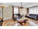 Living room with leather sofas, a coffee table, and large windows at 1219 Tucson St, Aurora, CO 80011