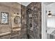 Clean bathroom with dark marble shower and a view of a sink and toilet at 1219 Tucson St, Aurora, CO 80011