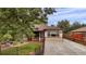 Front yard view of charming house with red walkway at 1219 Tucson St, Aurora, CO 80011