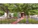 House exterior with landscaping, pond, and black fence at 1219 Tucson St, Aurora, CO 80011