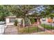 House exterior with pond, landscaping, and black fence at 1219 Tucson St, Aurora, CO 80011