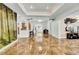 Bright living room with tile floors, large artwork, and a modern TV stand at 1219 Tucson St, Aurora, CO 80011