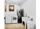 Laundry room with washer, dryer, and utility sink at 1219 Tucson St, Aurora, CO 80011