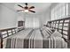 Spacious bedroom with wood floors and a ceiling fan, featuring a king-size bed at 1219 Tucson St, Aurora, CO 80011