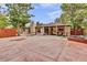 Large backyard with patio, covered seating area and a fire pit at 1219 Tucson St, Aurora, CO 80011