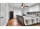 Bright bedroom with wood floors, a king-size bed, and a ceiling fan at 1219 Tucson St, Aurora, CO 80011