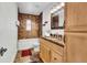Updated bathroom with a granite vanity, tiled shower, and a large mirror at 1219 Tucson St, Aurora, CO 80011
