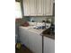 Laundry room with washer, dryer, and cabinets at 1053 N Colorado Blvd, Denver, CO 80206
