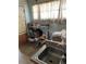 Small kitchen area with sink and storage shelves at 1053 N Colorado Blvd, Denver, CO 80206