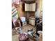 A fixer-upper kitchen, partially demoed, with cabinets and boxes at 1053 N Colorado Blvd, Denver, CO 80206