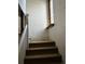 Interior staircase with carpeted steps and a glass block window at 1053 N Colorado Blvd, Denver, CO 80206