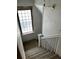Looking down an interior staircase with glass block window and simple wooden bannister at 1053 N Colorado Blvd, Denver, CO 80206