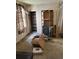A room with vintage wallpaper, shelving, and various items at 1053 N Colorado Blvd, Denver, CO 80206