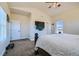 Bedroom with TV, carpet, and multiple windows at 738 S Main St, Byers, CO 80103