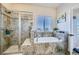 Bathroom with shower, tub, and window at 738 S Main St, Byers, CO 80103