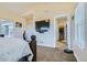 Main bedroom with ensuite bathroom access and large TV at 738 S Main St, Byers, CO 80103