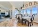 Open dining area with hardwood floors and view into living room at 738 S Main St, Byers, CO 80103