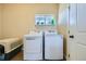 Laundry room with washer, dryer, and extra storage at 738 S Main St, Byers, CO 80103