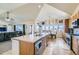 Open kitchen boasts stainless steel appliances and an island at 738 S Main St, Byers, CO 80103