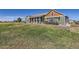 Ranch style home with green siding and red door at 738 S Main St, Byers, CO 80103