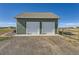 Two-car garage with attached driveway at 738 S Main St, Byers, CO 80103