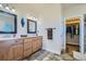 Bathroom with double vanity, large mirror and walk-in closet at 738 S Main St, Byers, CO 80103