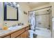 Bathroom with shower/tub combo and wooden vanity at 738 S Main St, Byers, CO 80103