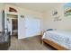 Bedroom with double doors and adjacent bathroom at 738 S Main St, Byers, CO 80103