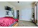 Bedroom with double doors, TV, and guitar at 738 S Main St, Byers, CO 80103