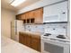 Efficient galley kitchen with wood cabinets and appliances at 1020 15Th St # 37I, Denver, CO 80202