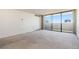 Spacious living room with wall-to-wall carpet and sliding glass door to balcony at 1020 15Th St # 37I, Denver, CO 80202