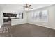 Living room with wood-look flooring, ceiling fan, and view of the kitchen at 5676 S Wenatchee St, Aurora, CO 80015