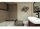 Basement bathroom with a tub and updated vanity at 4542 Sheridan Blvd, Denver, CO 80212