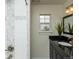 Modern bathroom with dark vanity and tiled shower at 4542 Sheridan Blvd, Denver, CO 80212