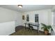 Bright home office features a metal desk, chair, and plant at 4542 Sheridan Blvd, Denver, CO 80212