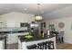 Modern kitchen with a large island, stainless steel appliances, and granite countertops at 4542 Sheridan Blvd, Denver, CO 80212