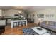 Open floor plan with hardwood floors, modern kitchen, and comfy living area at 4542 Sheridan Blvd, Denver, CO 80212