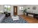 Bright living room with hardwood floors, comfy seating, and large windows at 4542 Sheridan Blvd, Denver, CO 80212