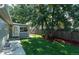 Side yard with mature tree, wood fence, and walkway at 4542 Sheridan Blvd, Denver, CO 80212
