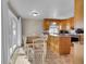 Bright dining area adjacent to the kitchen with sliding glass doors to a patio at 8160 W 81St Pl, Arvada, CO 80005