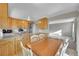 Eat-in kitchen with wood cabinets, granite counters, and stainless steel appliances at 8160 W 81St Pl, Arvada, CO 80005